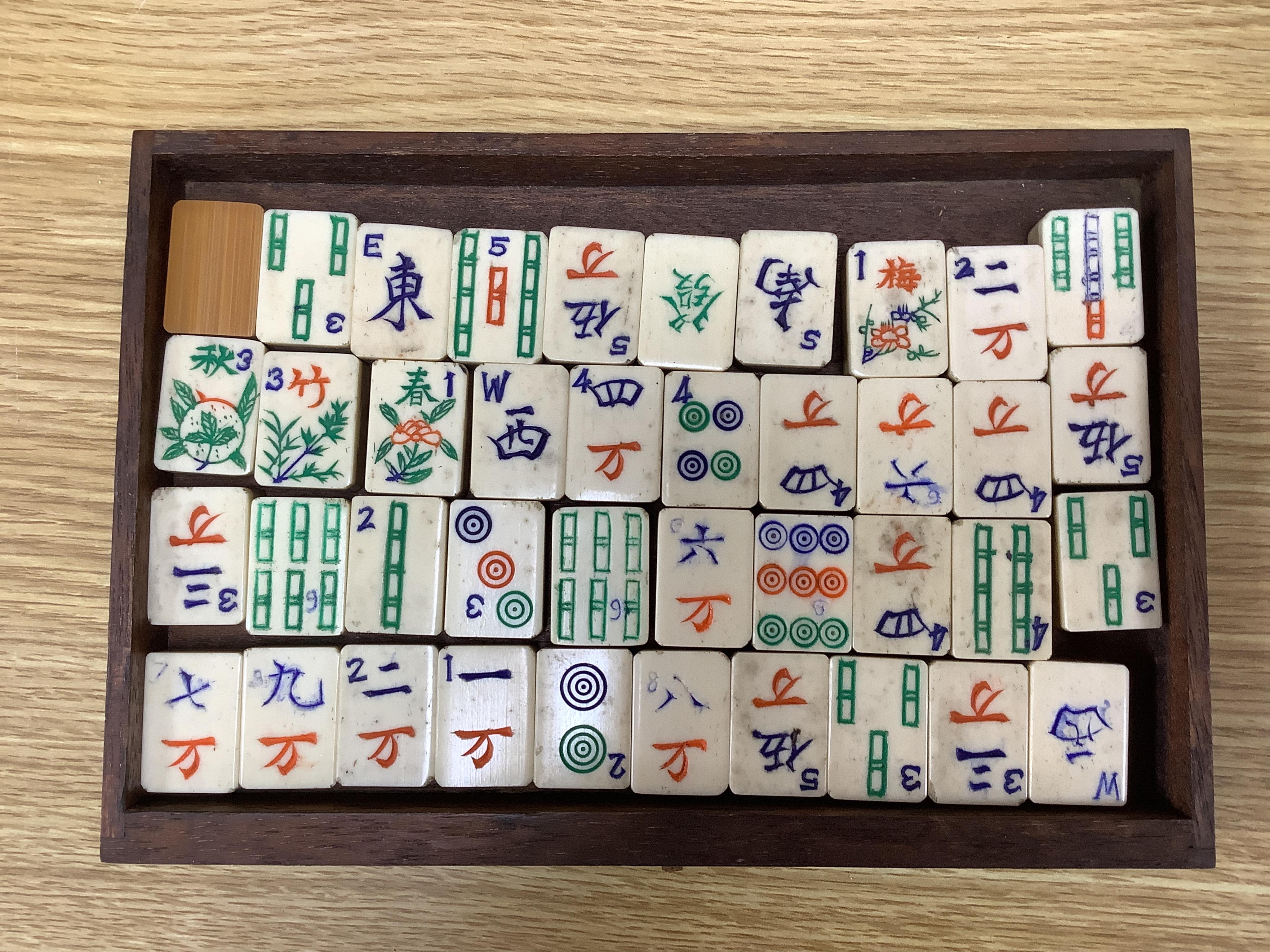 A cased Chinese Mahjong set, bone pieces